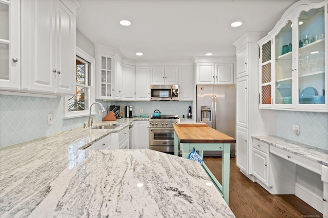 35 Knollcrest Rd, New Fairfield, CT 06812 - kitchen with stainless steel appliances, a sink, backsplash, white cabinetry, and dark wood finished floors
