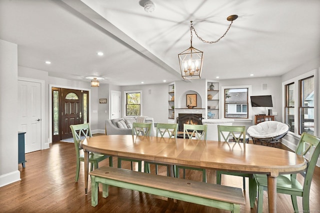 35 Knollcrest Rd, New Fairfield, CT 06812 - dining room with baseboards, wood finished floors, recessed lighting, a lit fireplace, and a chandelier