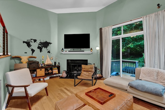 2390 State St Apt 6E, Hamden, CT 06517 - living room featuring wood finished floors and a fireplace with flush hearth
