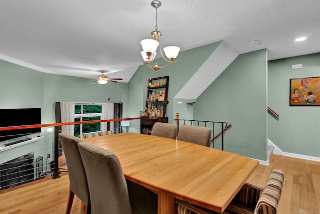 2390 State St Apt 6E, Hamden, CT 06517 - dining area featuring a chandelier, a ceiling fan, wood finished floors, a textured ceiling, and vaulted ceiling
