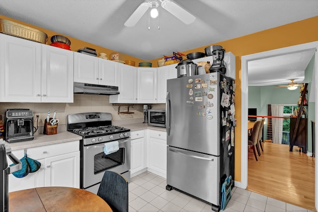 2390 State St Apt 6E, Hamden, CT 06517 - kitchen featuring stainless steel appliances, ceiling fan, under cabinet range hood, light countertops, and light tile patterned flooring