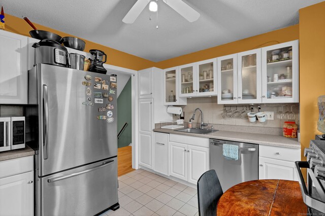 2390 State St Apt 6E, Hamden, CT 06517 - kitchen featuring appliances with stainless steel finishes, light tile patterned floors, and white cabinetry