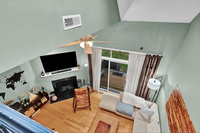 2390 State St Apt 6E, Hamden, CT 06517 - living room with wood finished floors, a fireplace with flush hearth, a towering ceiling, and a ceiling fan