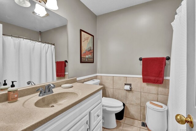 2390 State St Apt 6E, Hamden, CT 06517 - bathroom featuring tile walls, tile patterned flooring, vanity, and wainscoting