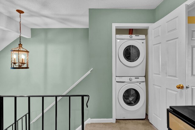 2390 State St Apt 6E, Hamden, CT 06517 - laundry area with stacked washer / drying machine, light colored carpet, a chandelier, and a textured ceiling