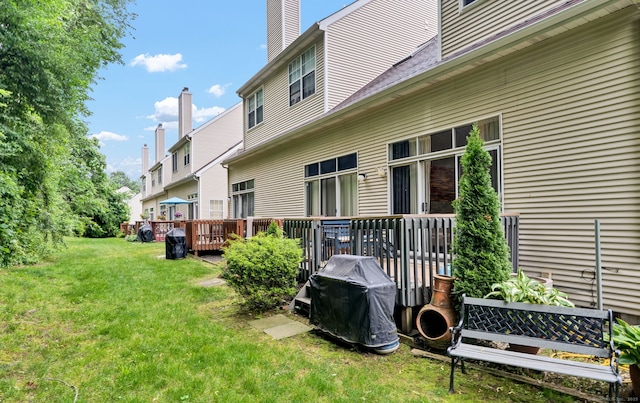 2390 State St Apt 6E, Hamden, CT 06517 - back of house featuring a yard, a wooden deck, and a chimney