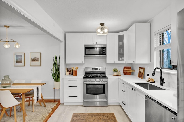 124 High Path Rd Unit 124, Windsor, CT 06095 - kitchen featuring appliances with stainless steel finishes, a sink, decorative backsplash, light countertops, and white cabinetry