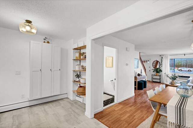 124 High Path Rd Unit 124, Windsor, CT 06095 - hallway featuring light wood-style floors, a textured ceiling, and baseboards