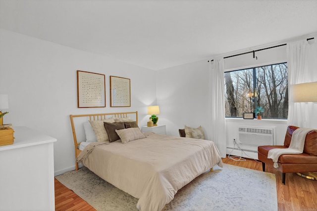 124 High Path Rd Unit 124, Windsor, CT 06095 - bedroom with an AC wall unit, light wood-style floors, and baseboards