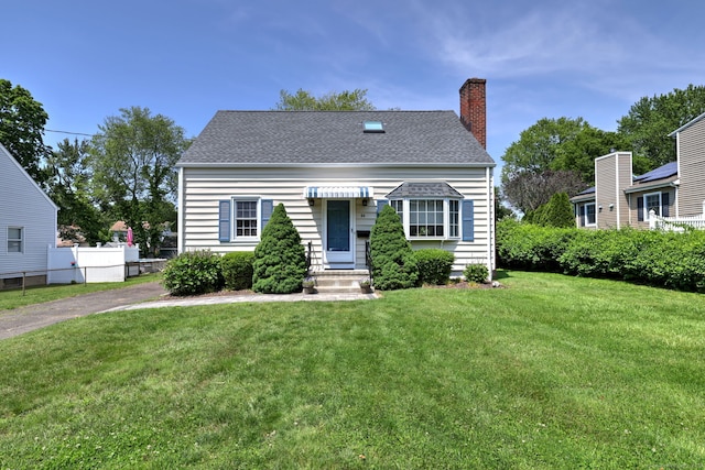 84 Kenwood Ave, Stratford, CT 06614 - view of front of property with a chimney, a front yard, and roof with shingles