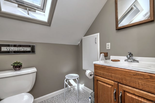 84 Kenwood Ave, Stratford, CT 06614 - half bath with vaulted ceiling, a skylight, vanity, and tile patterned flooring