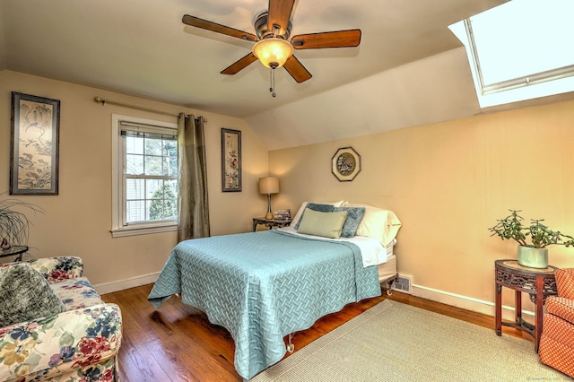 84 Kenwood Ave, Stratford, CT 06614 - bedroom with hardwood / wood-style floors, vaulted ceiling, a skylight, and a ceiling fan