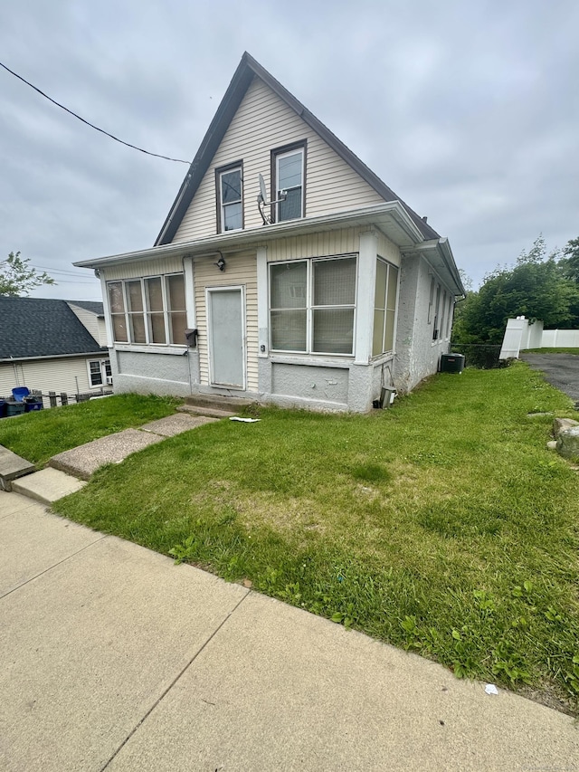 28 Terrace Ave, West Haven, CT 06516 - bungalow with cooling unit, a front yard, entry steps, and a sunroom