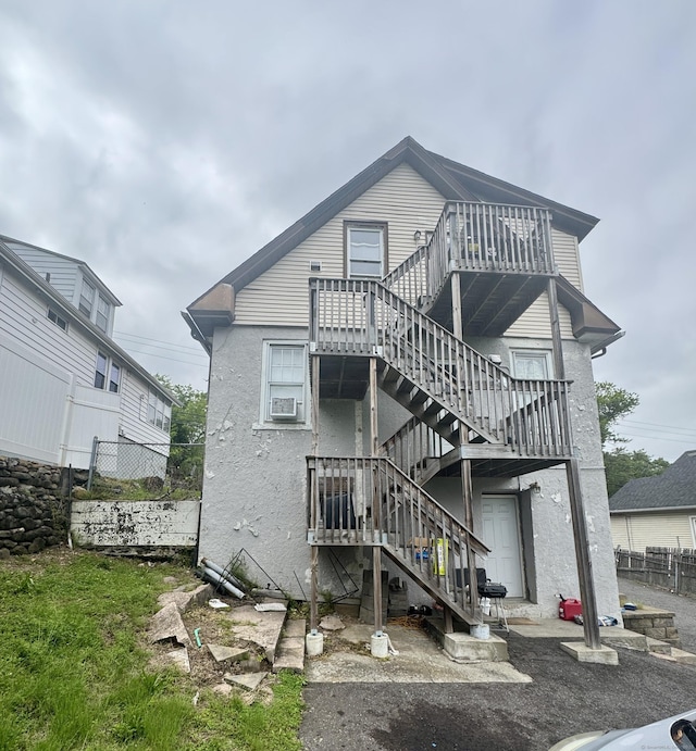 28 Terrace Ave, West Haven, CT 06516 - rear view of property with stairs and stucco siding