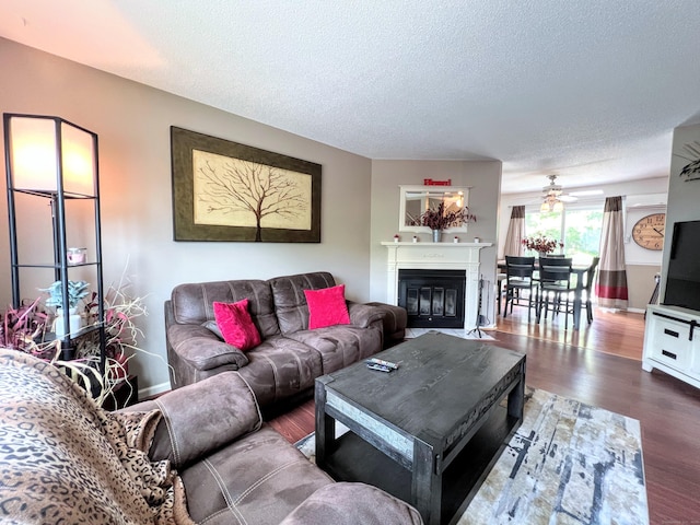 925 Oronoke Rd Unit 36G, Waterbury, CT 06708 - living room with a textured ceiling, ceiling fan, wood finished floors, a fireplace with flush hearth, and baseboards