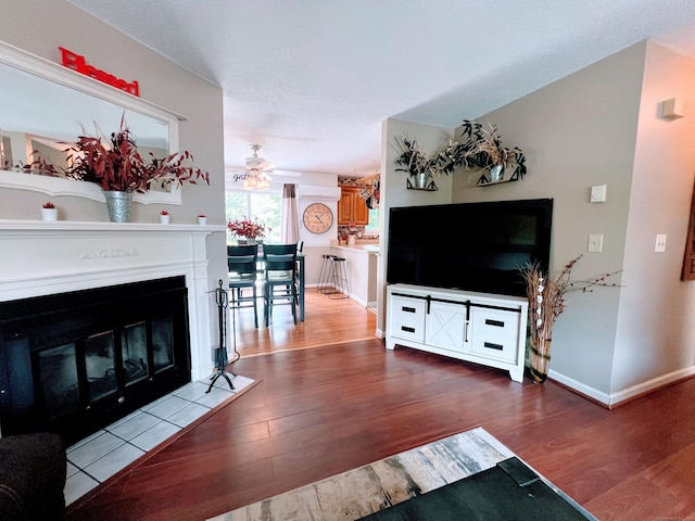 925 Oronoke Rd Unit 36G, Waterbury, CT 06708 - living room featuring wood finished floors, ceiling fan, a fireplace with flush hearth, and baseboards