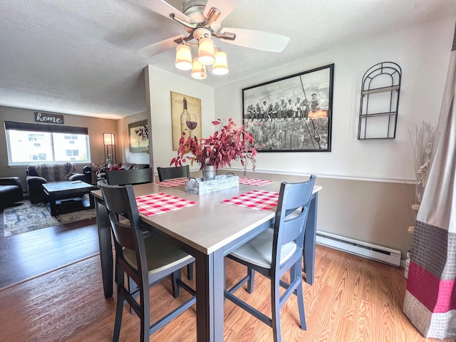 925 Oronoke Rd Unit 36G, Waterbury, CT 06708 - dining room with a baseboard heating unit, a textured ceiling, wood finished floors, and a ceiling fan
