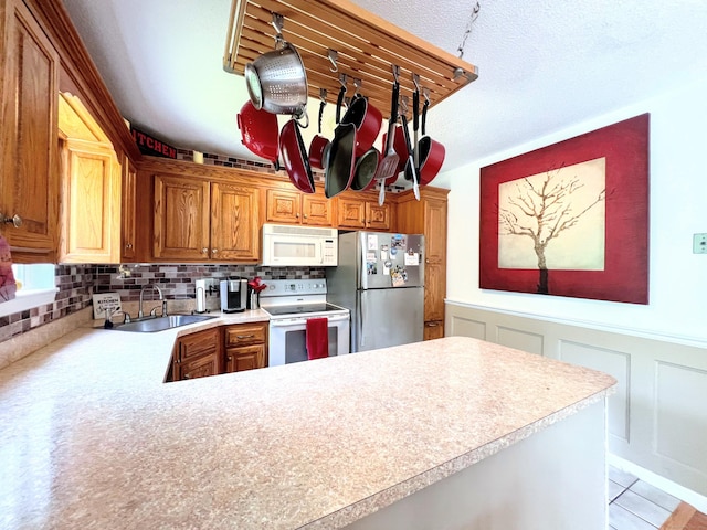 925 Oronoke Rd Unit 36G, Waterbury, CT 06708 - kitchen with white appliances, a sink, light countertops, a decorative wall, and tasteful backsplash