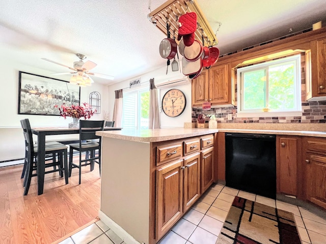 925 Oronoke Rd Unit 36G, Waterbury, CT 06708 - kitchen featuring dishwasher, brown cabinetry, light countertops, and a peninsula