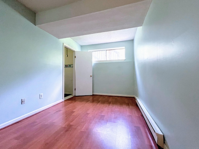 925 Oronoke Rd Unit 36G, Waterbury, CT 06708 - unfurnished room featuring a baseboard radiator, wood finished floors, and baseboards