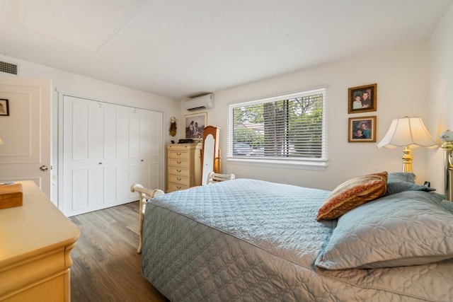 543 Heritage Vlg Unit A, Southbury, CT 06488 - bedroom with an AC wall unit, wood finished floors, and a closet