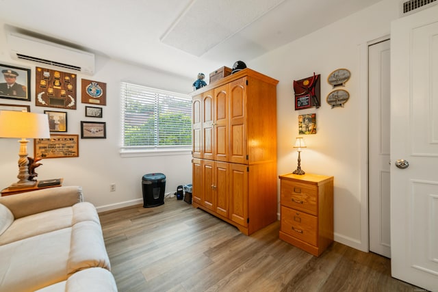 543 Heritage Vlg Unit A, Southbury, CT 06488 - living room featuring a wall mounted air conditioner and wood finished floors