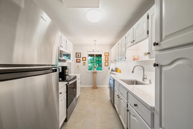 543 Heritage Vlg Unit A, Southbury, CT 06488 - kitchen featuring stainless steel appliances, decorative backsplash, light countertops, a chandelier, and white cabinetry