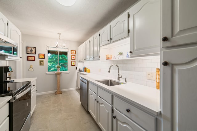 543 Heritage Vlg Unit A, Southbury, CT 06488 - kitchen with appliances with stainless steel finishes, decorative backsplash, light countertops, a textured ceiling, and a chandelier