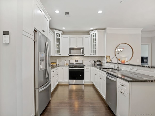 302 Center Meadow Ln Unit 302, Danbury, CT 06810 - kitchen with appliances with stainless steel finishes, a peninsula, tasteful backsplash, dark wood-style floors, and white cabinetry