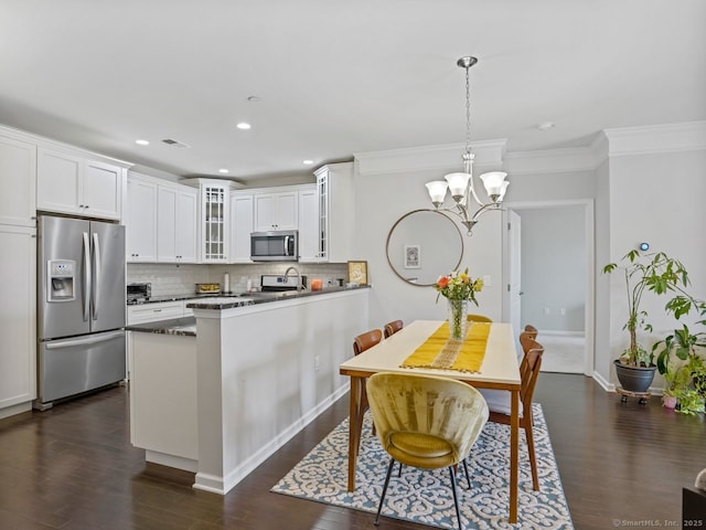 302 Center Meadow Ln Unit 302, Danbury, CT 06810 - kitchen with appliances with stainless steel finishes, a chandelier, backsplash, glass insert cabinets, and dark wood-type flooring