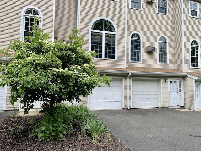 350 Bristol St Apt A3, Waterbury, CT 06708 - view of front of property featuring driveway, an attached garage, and a wall unit AC