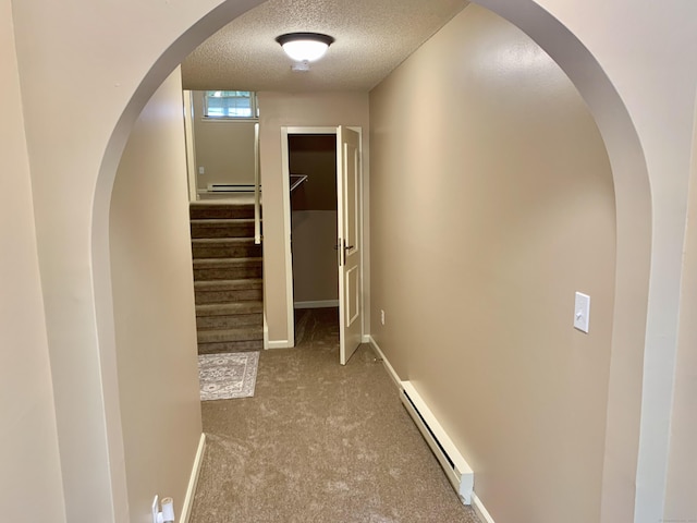 350 Bristol St Apt A3, Waterbury, CT 06708 - corridor with baseboard heating, a textured ceiling, carpet flooring, stairway, and baseboards