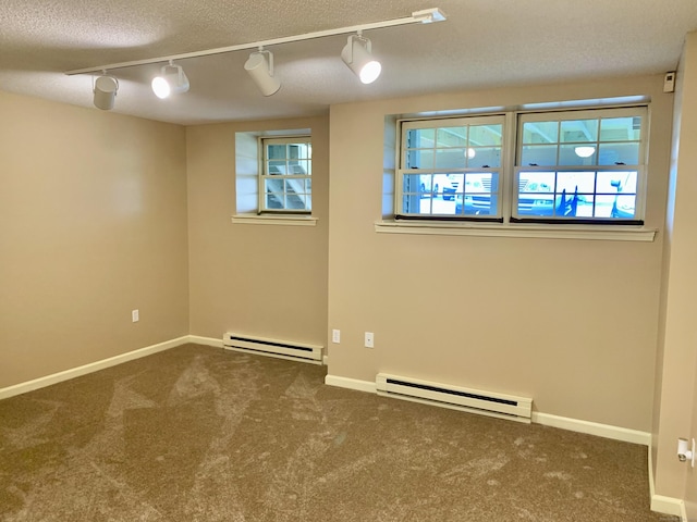 350 Bristol St Apt A3, Waterbury, CT 06708 - spare room featuring a baseboard heating unit, carpet, and rail lighting