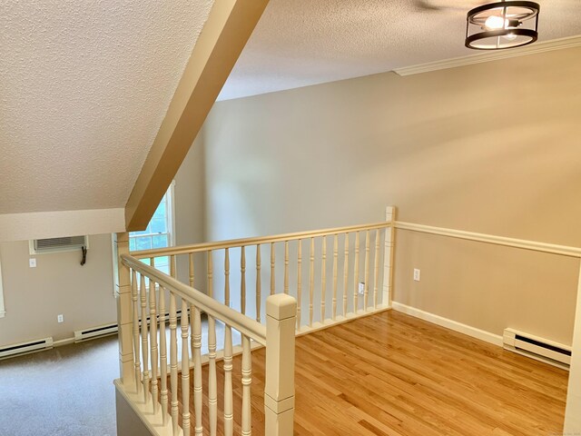 350 Bristol St Apt A3, Waterbury, CT 06708 - hallway with baseboard heating, a textured ceiling, baseboards, wood finished floors, and a wall mounted air conditioner