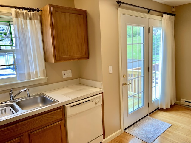 350 Bristol St Apt A3, Waterbury, CT 06708 - kitchen with dishwasher, brown cabinets, light wood-style flooring, light countertops, and a sink
