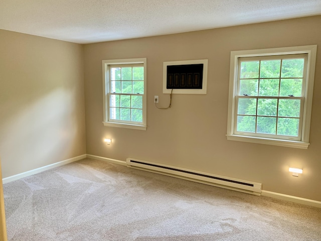 350 Bristol St Apt A3, Waterbury, CT 06708 - carpeted empty room with a baseboard heating unit, plenty of natural light, baseboards, and a textured ceiling