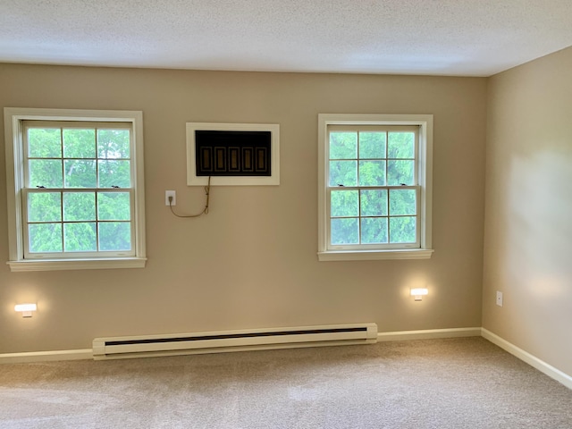 350 Bristol St Apt A3, Waterbury, CT 06708 - spare room featuring baseboard heating, a textured ceiling, carpet flooring, and baseboards