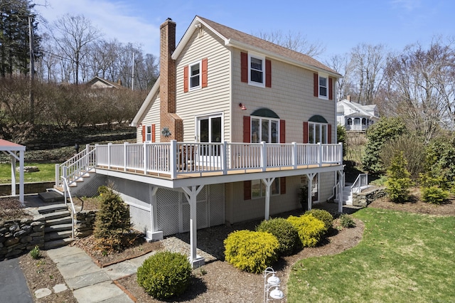 73 Lake Shore Dr, East Haddam, CT 06415 - back of house with a deck, a chimney, stairs, a yard, and a shingled roof