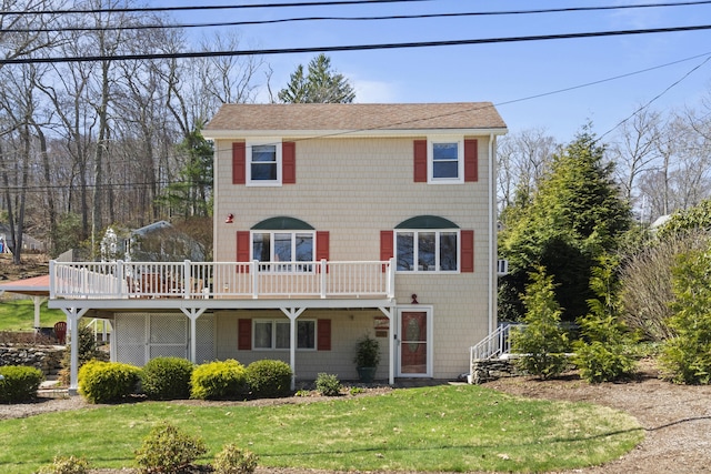 73 Lake Shore Dr, East Haddam, CT 06415 - view of front facade featuring a deck, a front yard, and a shingled roof