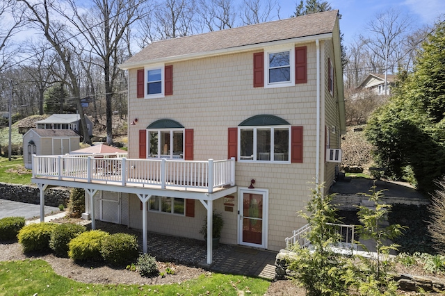 73 Lake Shore Dr, East Haddam, CT 06415 - rear view of house with a wooden deck, a shingled roof, a patio area, and cooling unit