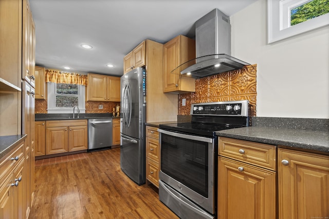 73 Lake Shore Dr, East Haddam, CT 06415 - kitchen with stainless steel appliances, wall chimney exhaust hood, a sink, dark wood finished floors, and decorative backsplash