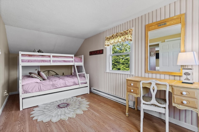 73 Lake Shore Dr, East Haddam, CT 06415 - bedroom featuring vaulted ceiling, wood finished floors, baseboards, wallpapered walls, and a baseboard radiator