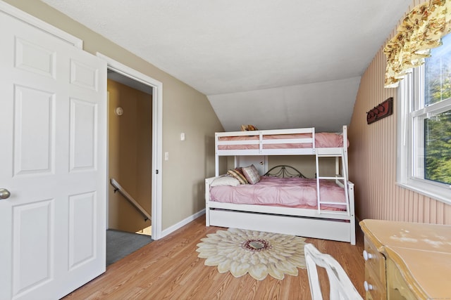73 Lake Shore Dr, East Haddam, CT 06415 - bedroom with light wood-type flooring, lofted ceiling, and baseboards
