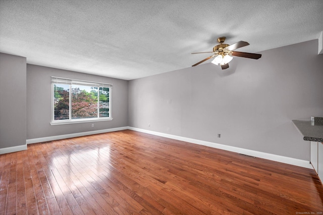 129 Knowles Ave Unit 129, Middletown, CT 06457 - unfurnished living room with a ceiling fan, wood-type flooring, a textured ceiling, and baseboards