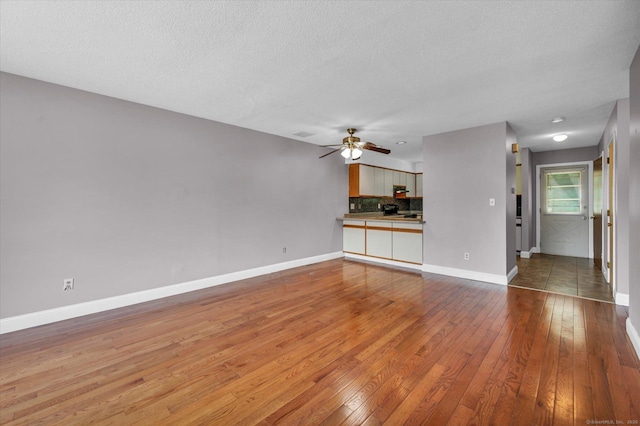 129 Knowles Ave Unit 129, Middletown, CT 06457 - unfurnished living room with wood-type flooring, ceiling fan, baseboards, and a textured ceiling