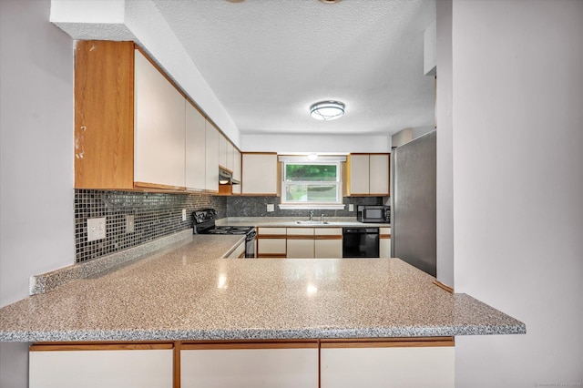 129 Knowles Ave Unit 129, Middletown, CT 06457 - kitchen with black appliances, a sink, tasteful backsplash, under cabinet range hood, and a peninsula