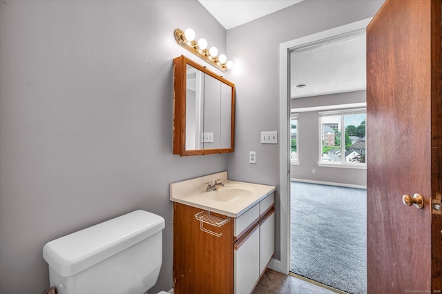 129 Knowles Ave Unit 129, Middletown, CT 06457 - bathroom featuring vanity, toilet, and baseboards