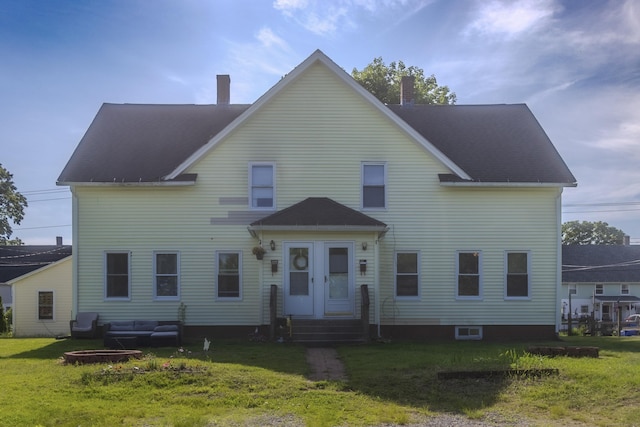 42 1st St, Plainfield, CT 06374 - view of front facade featuring a chimney, a front lawn, entry steps, an outdoor hangout area, and a shingled roof