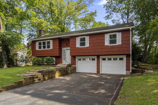 5 Robin Ln, New Haven, CT 06515 - bi-level home with driveway, a garage, a chimney, and a front lawn