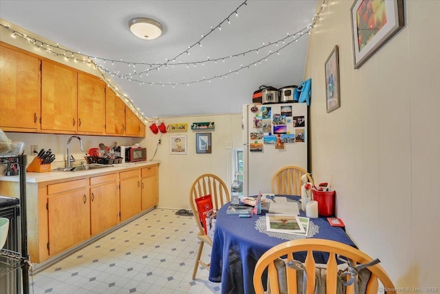 124 Main St, Sprague, CT 06330 - kitchen with freestanding refrigerator, light countertops, light flooring, black microwave, and brown cabinetry